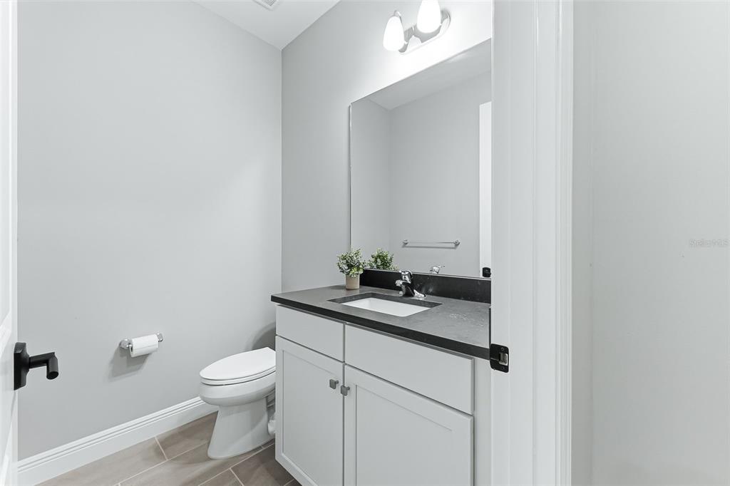 4191 Pegasus Way Naples, FL 34120 - Photo 31 of 48 a bathroom with a granite countertop sink a toilet and a mirror