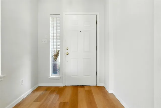 a view of a room with wooden floor and bathroom