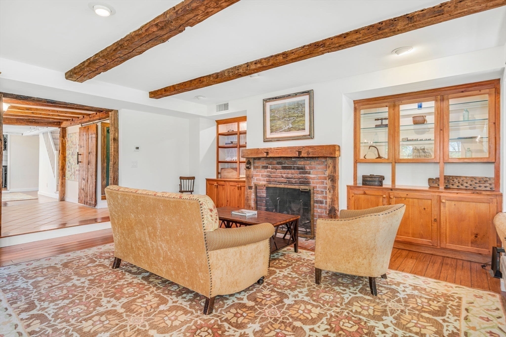 34 Everett Street Natick, MA 01760 - Photo 11 of 34 a living room with fireplace furniture and a large window