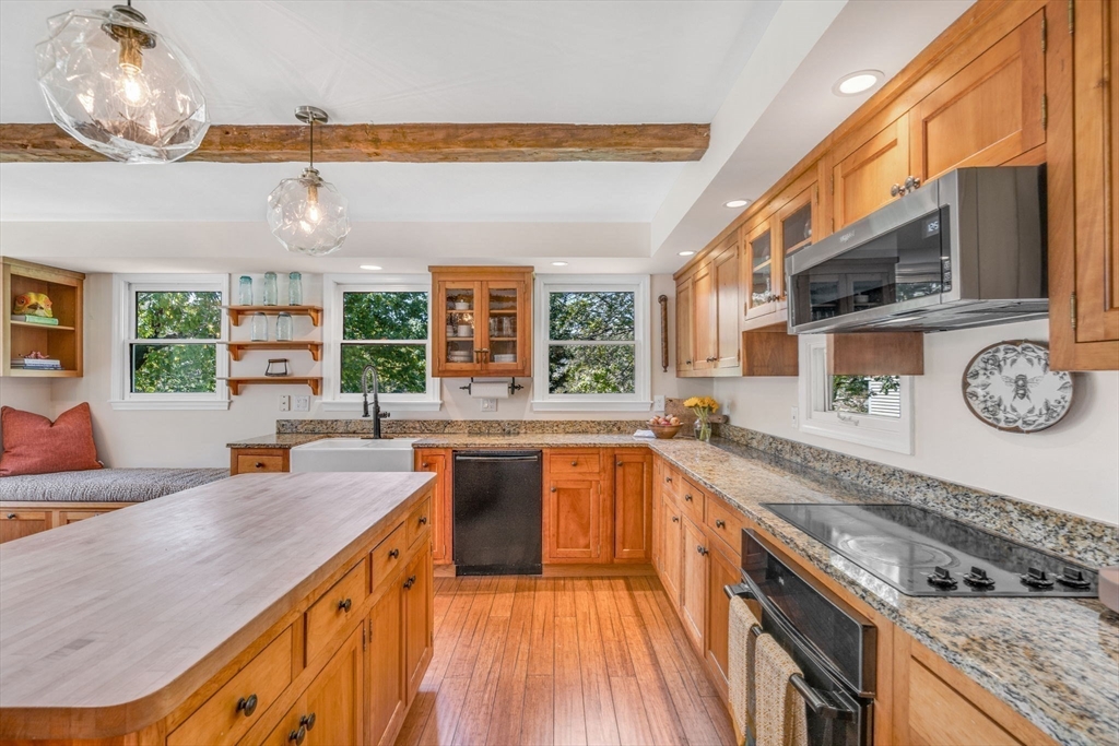 34 Everett Street Natick, MA 01760 - Photo 13 of 34 a large kitchen with stainless steel appliances granite countertop a sink and cabinets