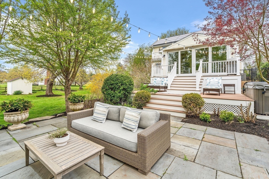 34 Everett Street Natick, MA 01760 - Photo 25 of 34 a view of a patio with couches table and chairs and garden