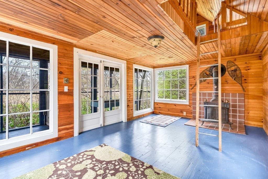 34 Everett Street Natick, MA 01760 - Photo 30 of 34 a hallway with wooden floor and next to a window