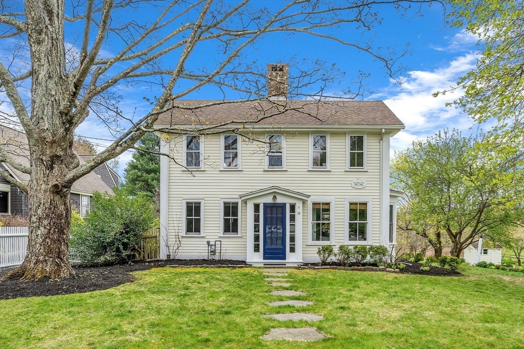 34 Everett Street Natick, MA 01760 - Photo 33 of 34 a front view of a house with a garden