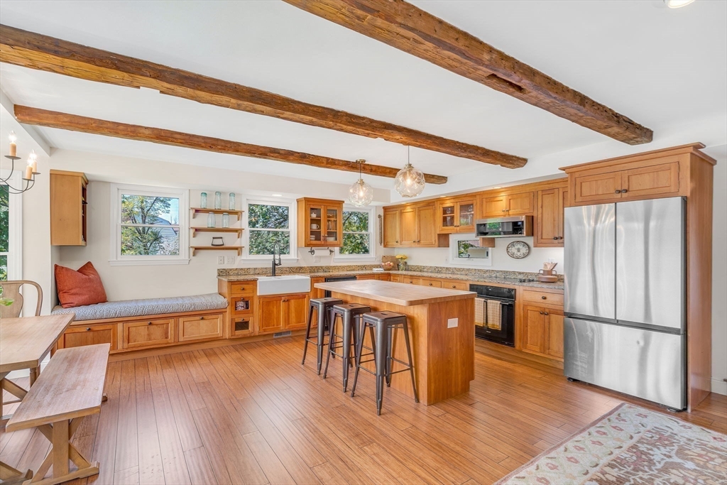 34 Everett Street Natick, MA 01760 - Photo 8 of 34 a kitchen with stainless steel appliances granite countertop a refrigerator a stove a sink and dishwasher with wooden floor