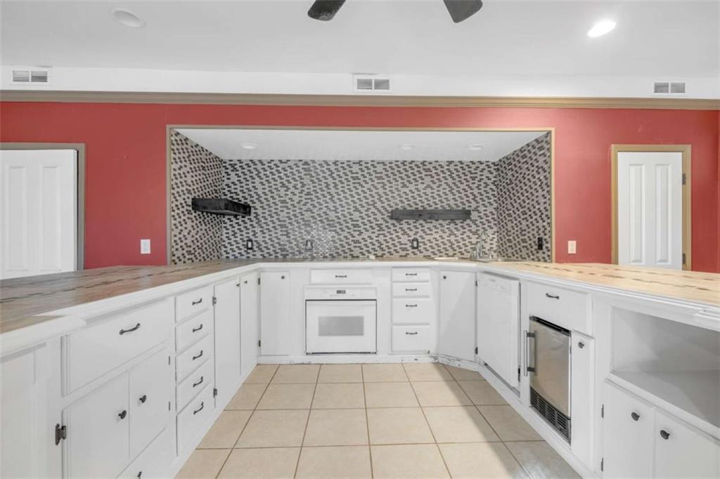 1256 Chambers Road McDonough, GA 30253 - Photo 15 of 49 a kitchen with granite countertop white cabinets and white appliances