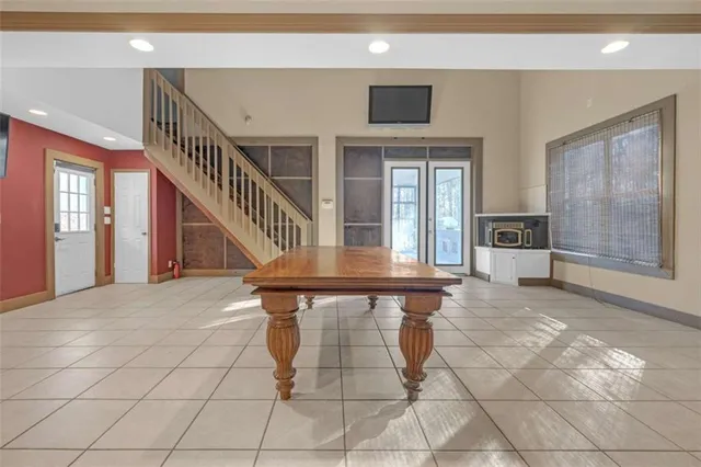 a spacious bedroom with a bed and glass door