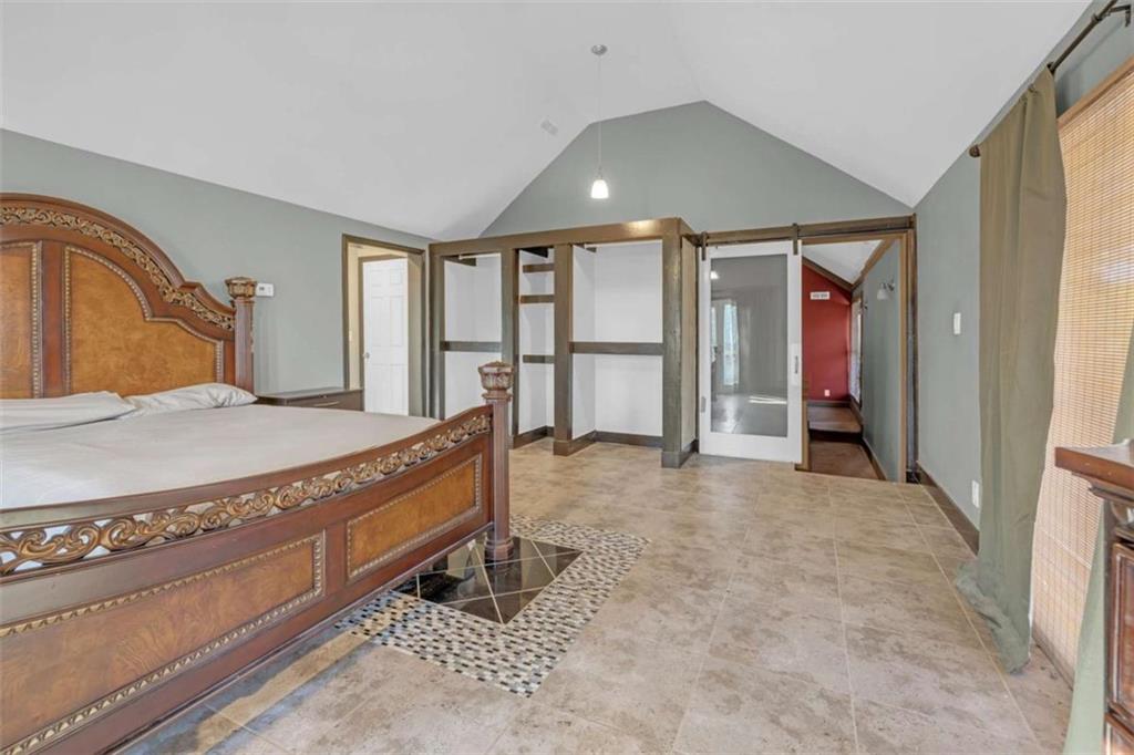 1256 Chambers Road McDonough, GA 30253 - Photo 19 of 49 a spacious bedroom with a bed and glass door