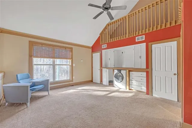 a bedroom with furniture and a large window