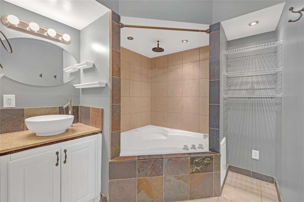 1256 Chambers Road McDonough, GA 30253 - Photo 27 of 49 a bathroom with a granite countertop sink a mirror and shower