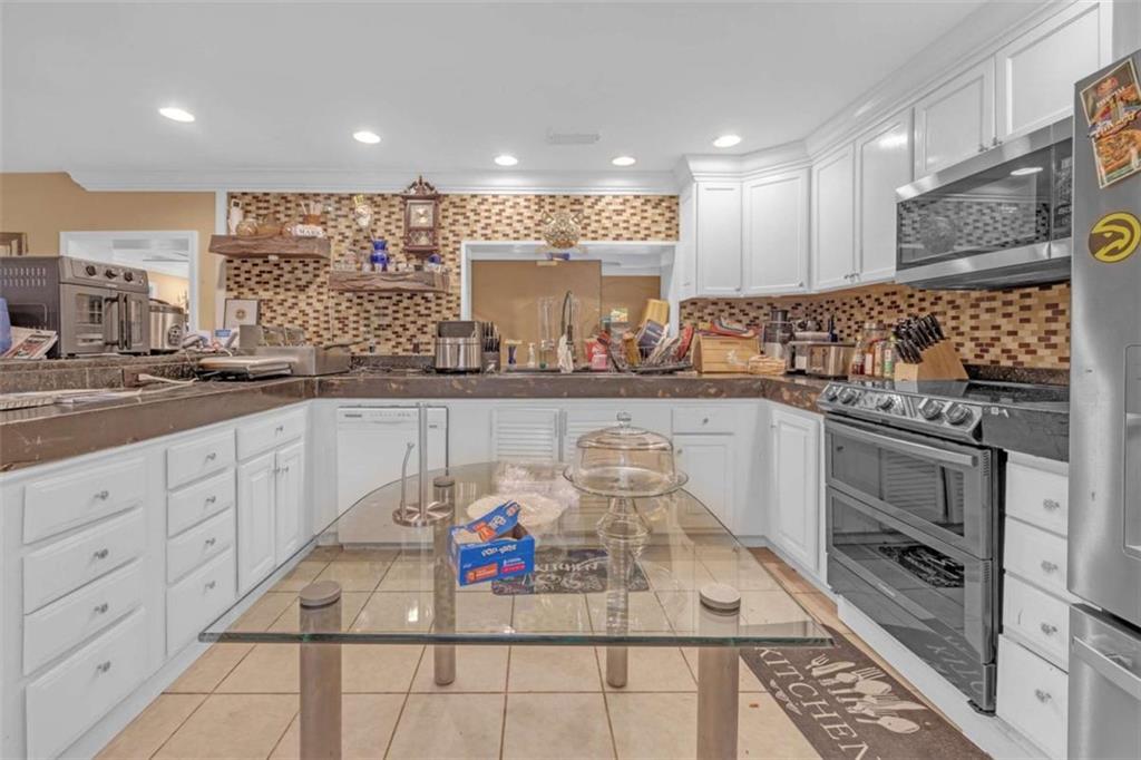 1256 Chambers Road McDonough, GA 30253 - Photo 30 of 49 a kitchen with stainless steel appliances granite countertop a sink and cabinets