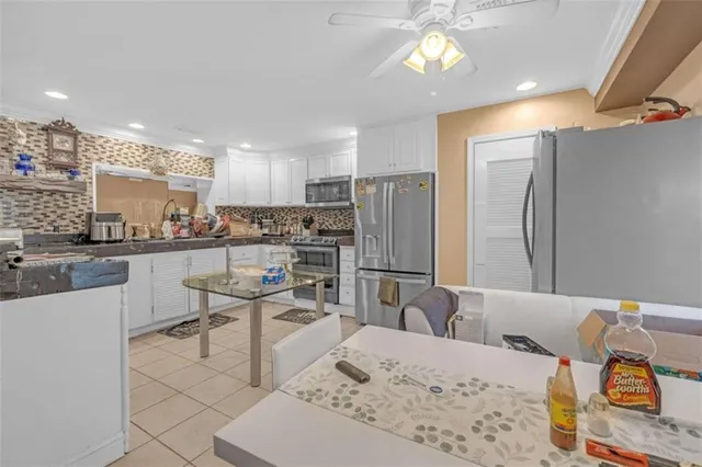 a living room with furniture and baby crib