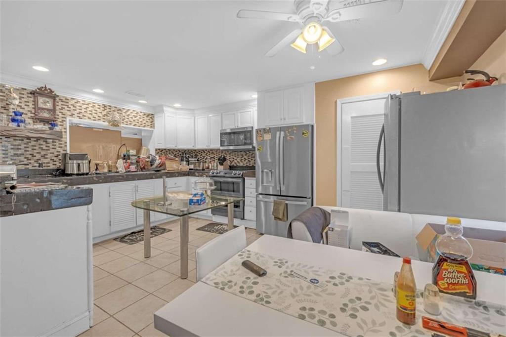 1256 Chambers Road McDonough, GA 30253 - Photo 31 of 49 a kitchen with stainless steel appliances kitchen island granite countertop a refrigerator and a stove top oven