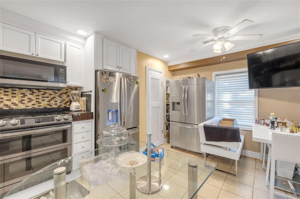 1256 Chambers Road McDonough, GA 30253 - Photo 32 of 49 a kitchen with stainless steel appliances kitchen island granite countertop a refrigerator and a stove top oven