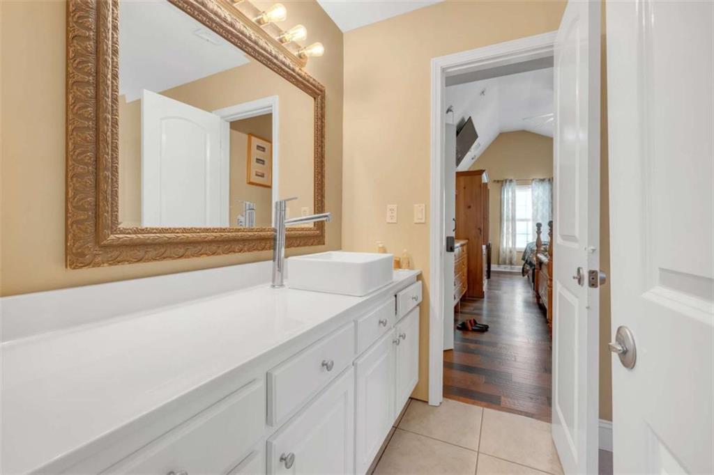1256 Chambers Road McDonough, GA 30253 - Photo 35 of 49 a bathroom with a sink and mirror with bathtub