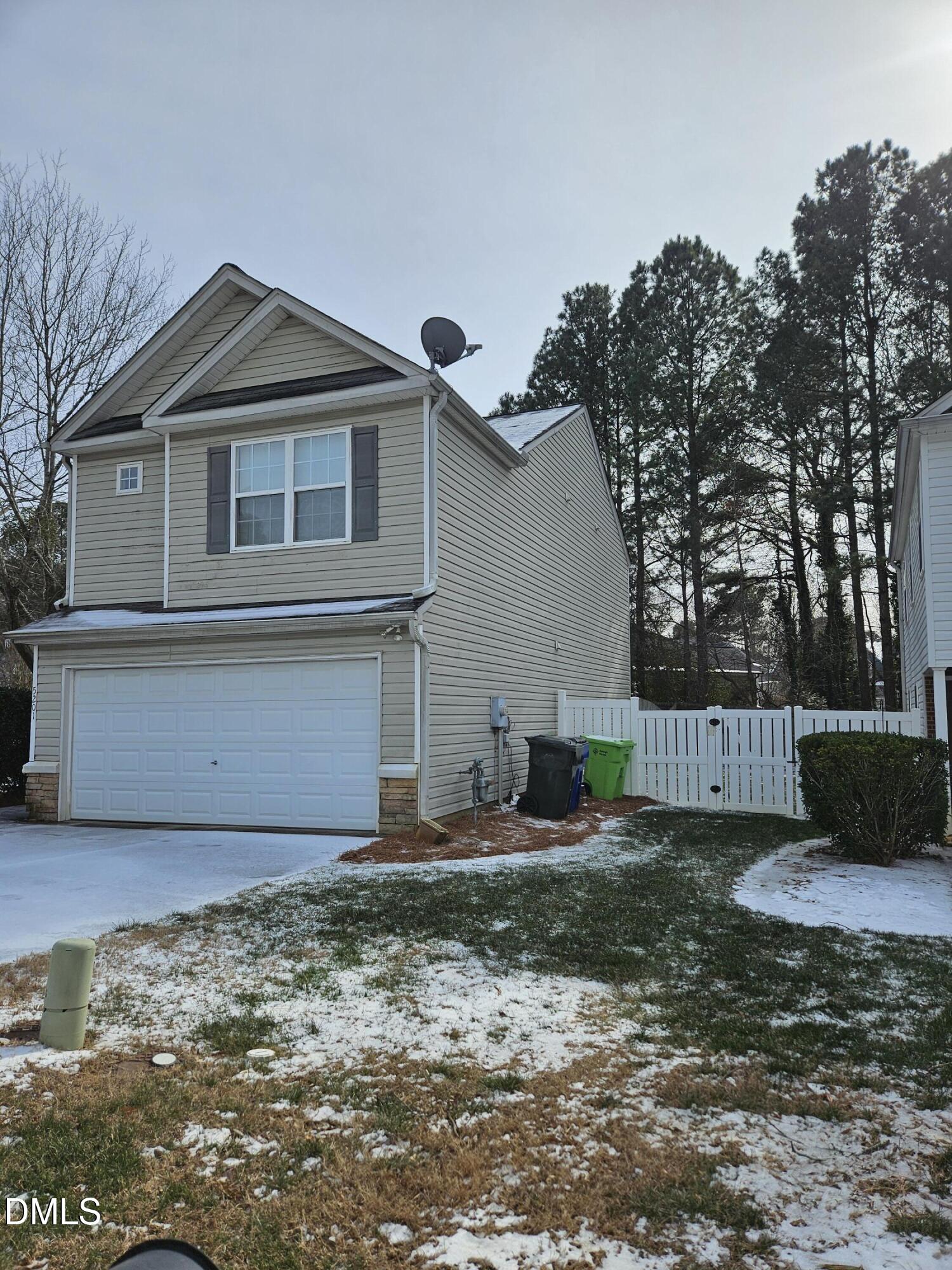 5201 Golden Moss Trail Raleigh, NC 27613 - Photo 2 of 10 a front view of a house with a yard and garage