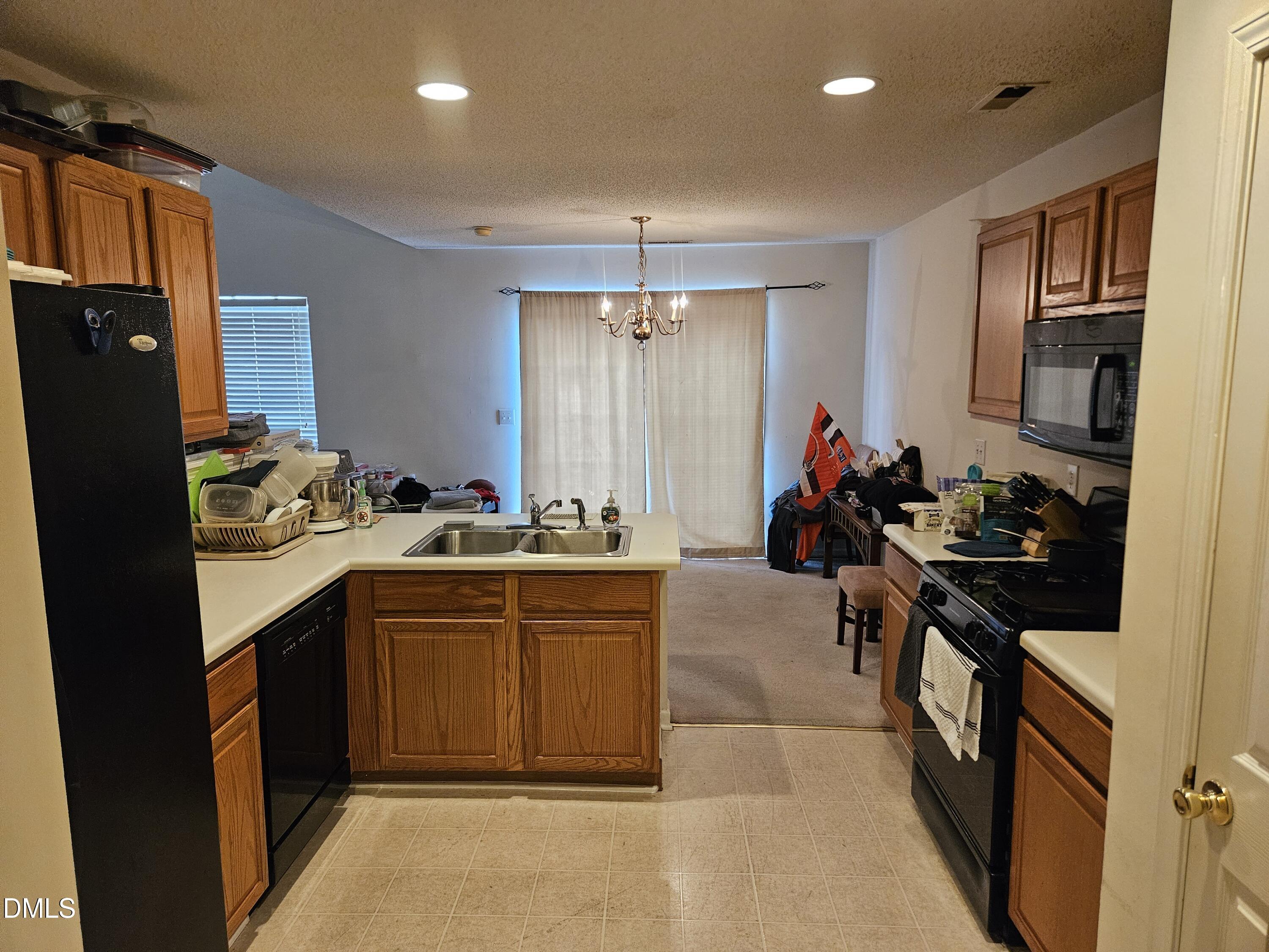 5201 Golden Moss Trail Raleigh, NC 27613 - Photo 7 of 10 a kitchen with a sink stove and refrigerator