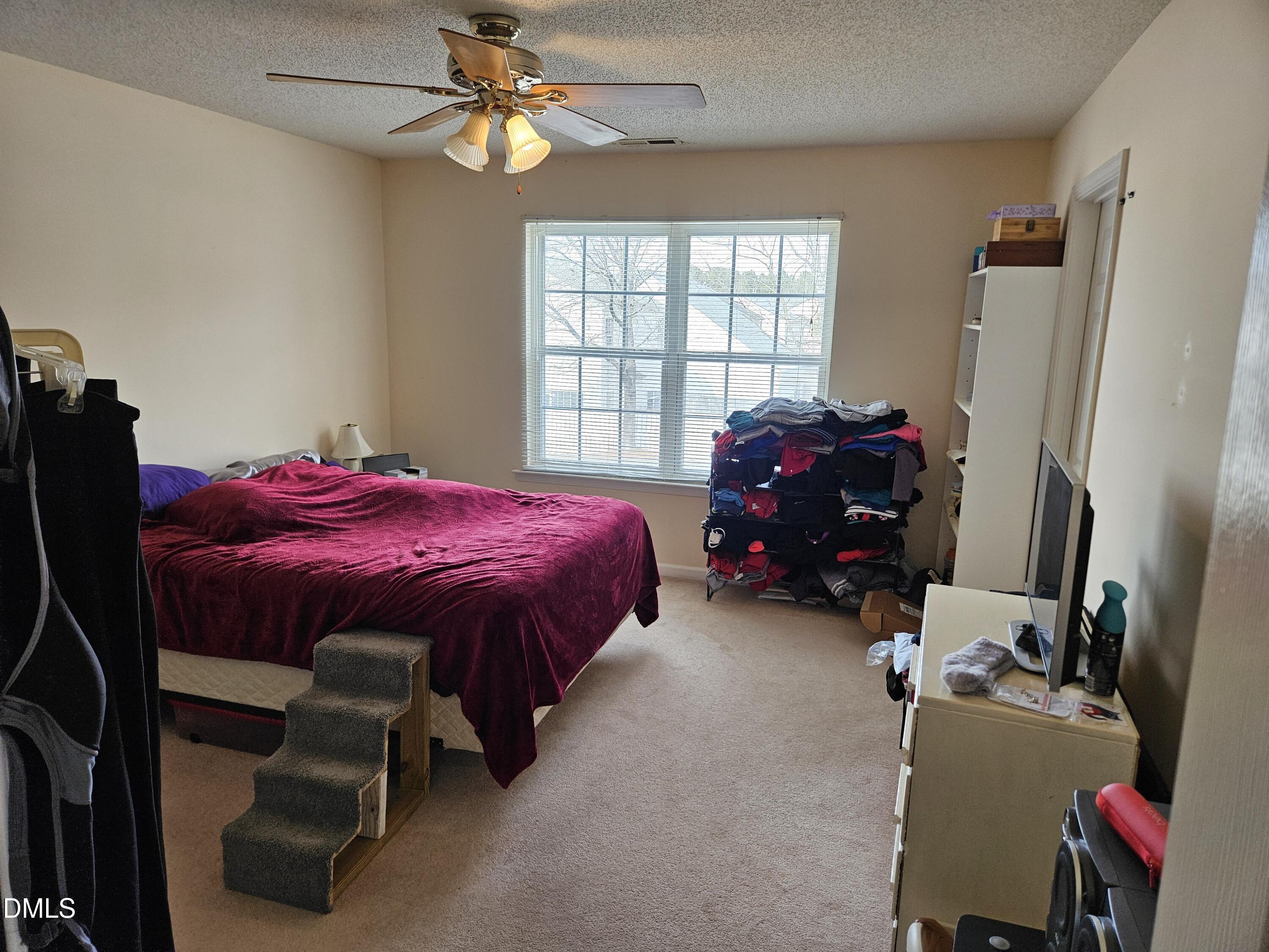 5201 Golden Moss Trail Raleigh, NC 27613 - Photo 9 of 10 a bed room with a bed and a window