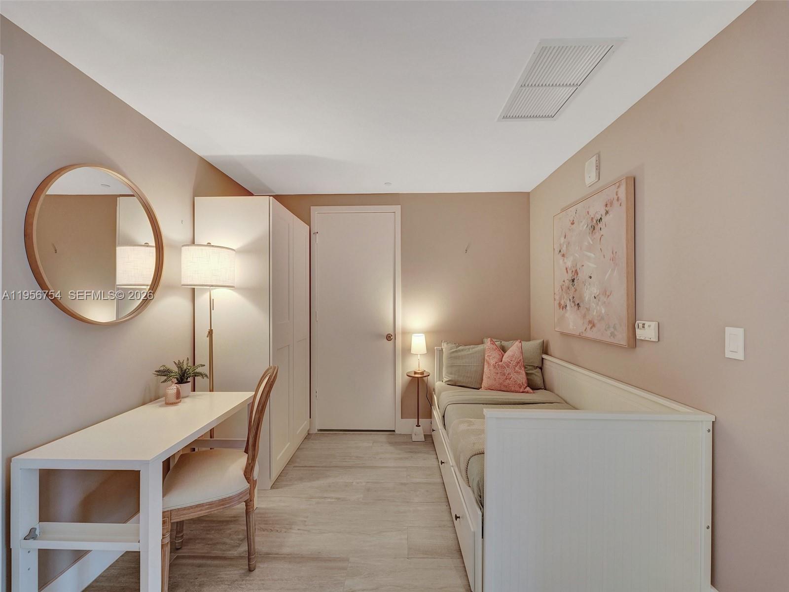 121 Northeast 34th Street, Unit 2106A Miami, FL 33137 - Photo 28 of 59 a room with a table chairs and a mirror