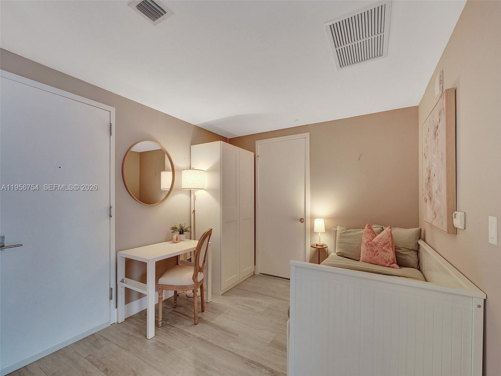 121 Northeast 34th Street, Unit 2106A Miami, FL 33137 - Photo 29 of 59 a room with furniture and a mirror