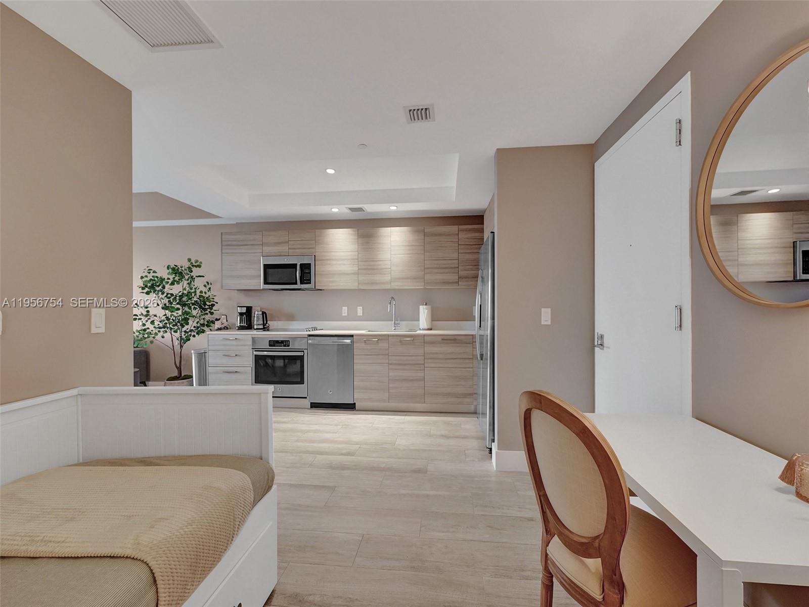 121 Northeast 34th Street, Unit 2106A Miami, FL 33137 - Photo 30 of 59 a living room with furniture a fireplace and a dining table with kitchen view