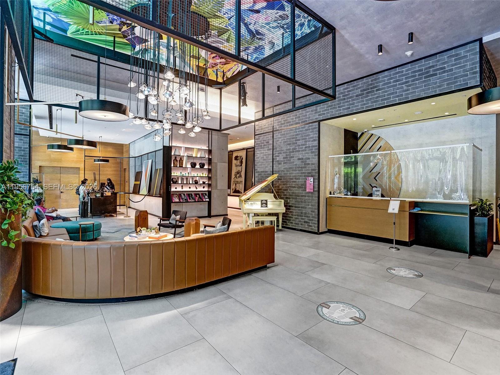 121 Northeast 34th Street, Unit 2106A Miami, FL 33137 - Photo 37 of 59 a living room with furniture and a flat screen tv