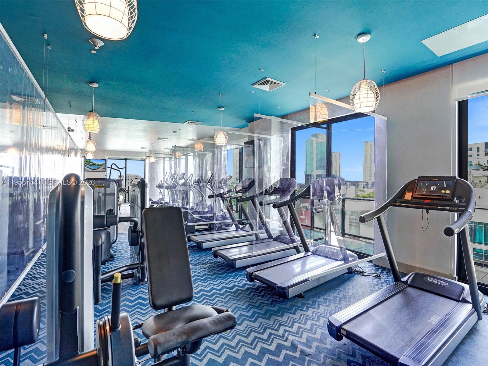 121 Northeast 34th Street, Unit 2106A Miami, FL 33137 - Photo 41 of 59 a view of a room with gym equipment