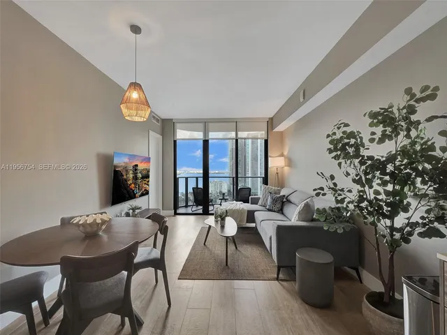 a living room with furniture and a large window