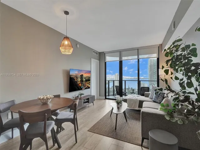 a living room with furniture and a large window