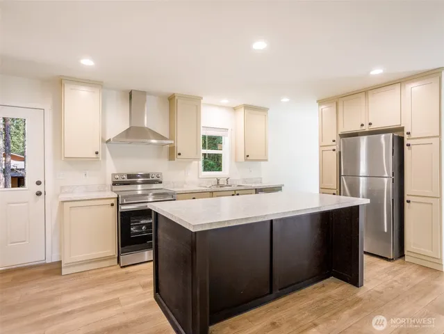 a kitchen with stainless steel appliances a sink stove and refrigerator