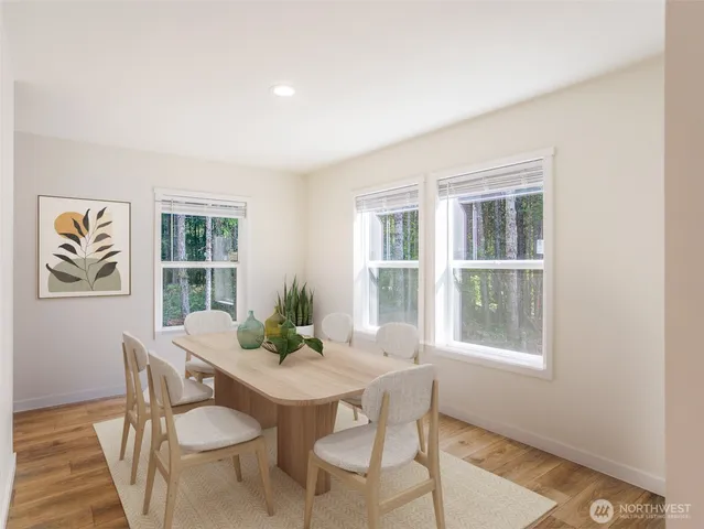 a view of a dining room with furniture window and wooden floor
