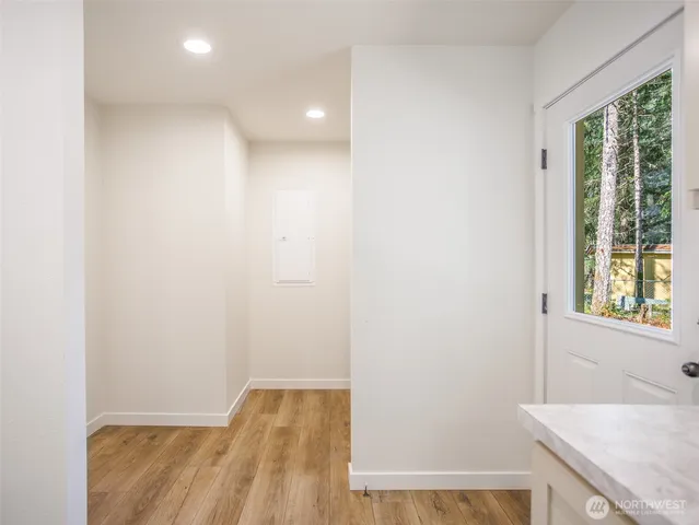 a view of hallway with a sink and a window