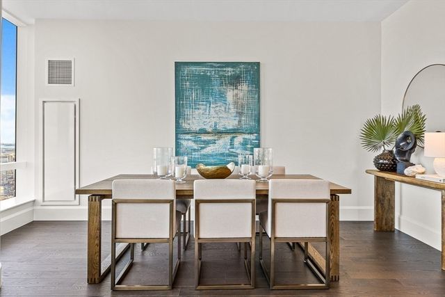 a dining room with furniture and window