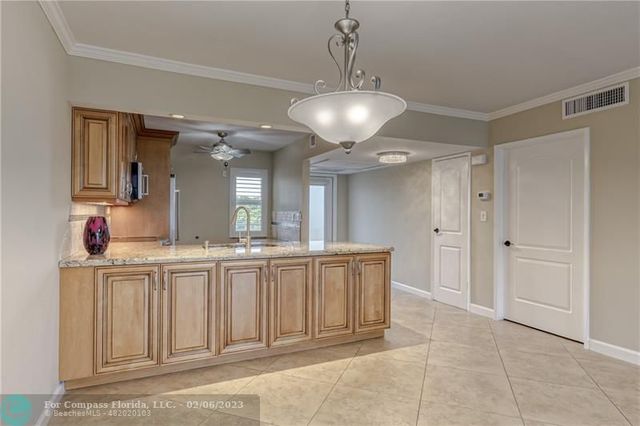 a kitchen with granite countertop a sink cabinets and window