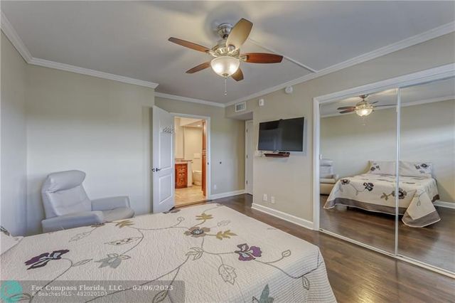 a spacious bathroom with a granite countertop sink a toilet and a mirror