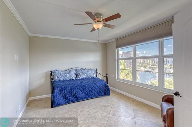 a living room with furniture and a ceiling fan