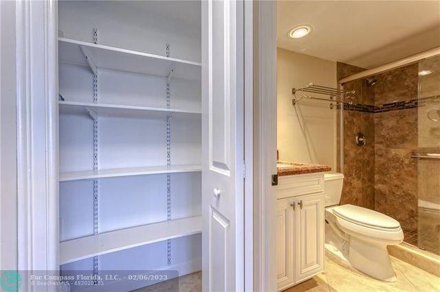 a view of a hallway with wooden floor and a living room