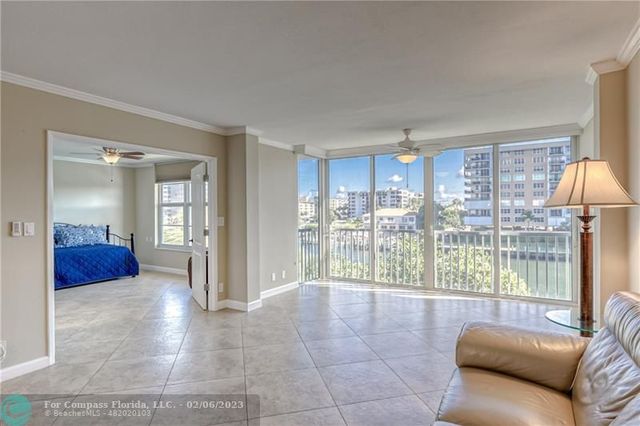 a living room with furniture and a large window with outer view