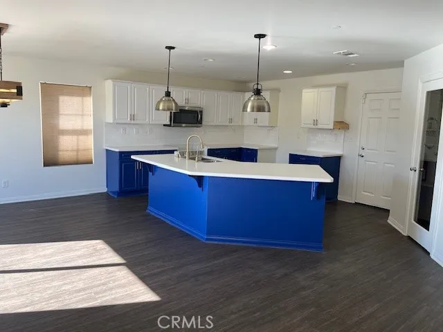 a kitchen with kitchen island granite countertop wooden cabinets and white appliances
