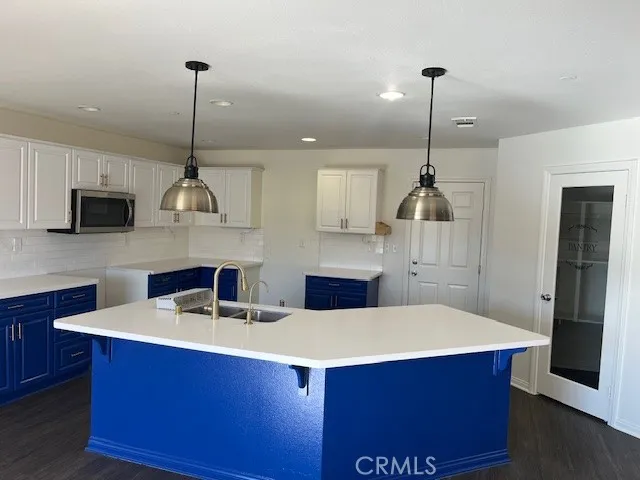 a kitchen with stainless steel appliances a sink a counter space and cabinets