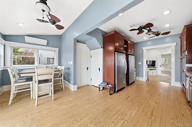 a view of a livingroom with furniture chandelier fan and wooden floor