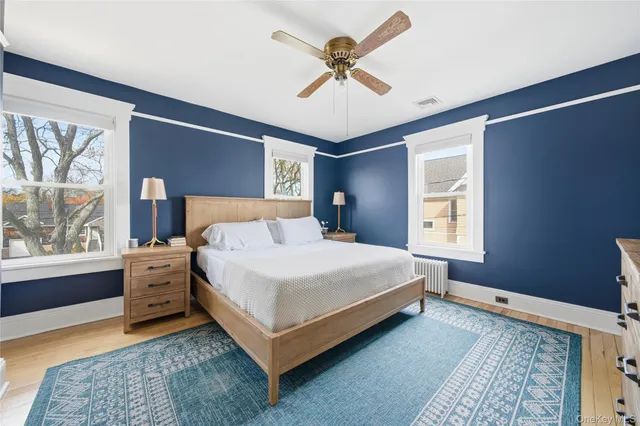 a bedroom with a large bed and a chandelier
