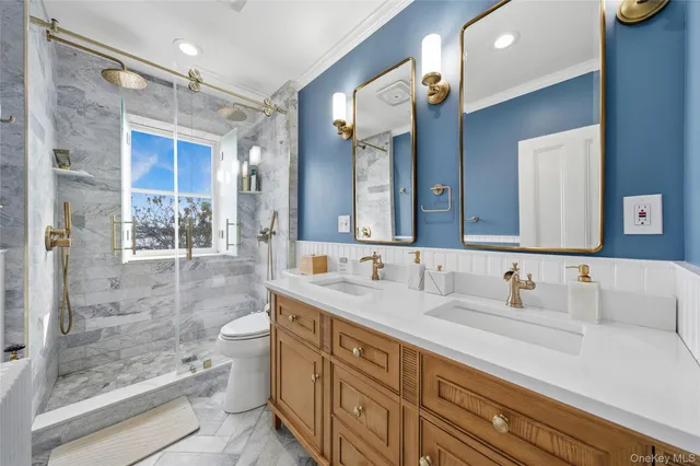 a bathroom with a double vanity sink mirror and shower