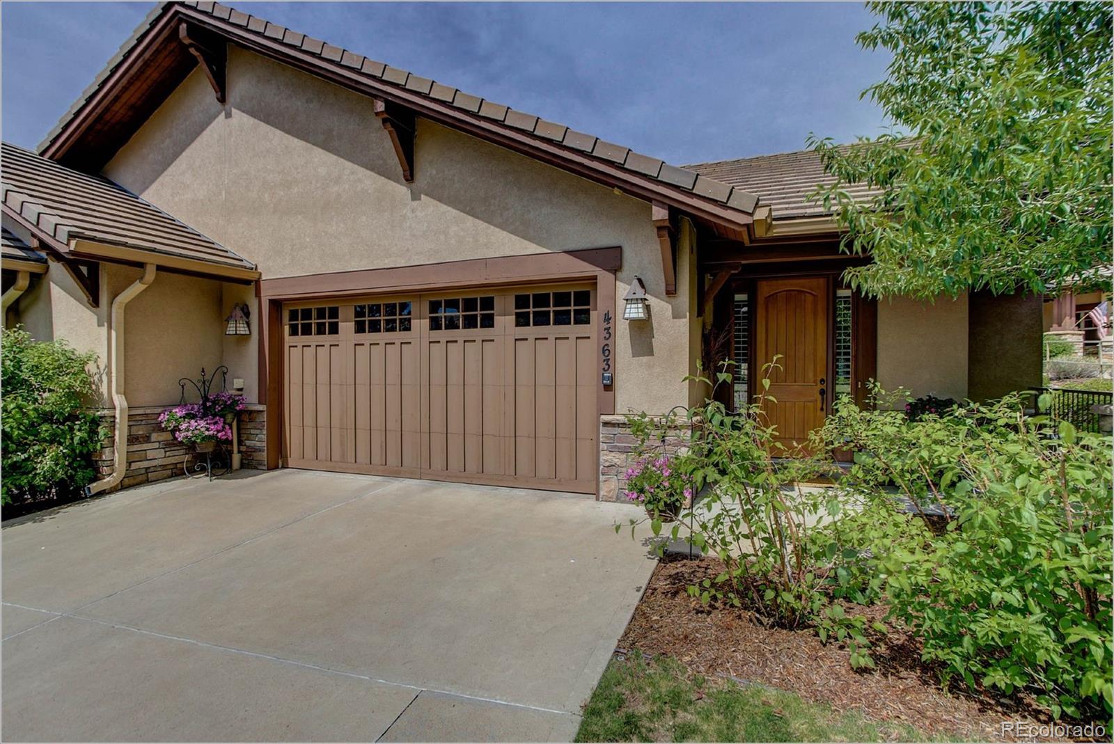 4363 Chateau Ridge Lane Castle Rock, CO 80108 - Photo 1 of 32 a front view of a house with garden