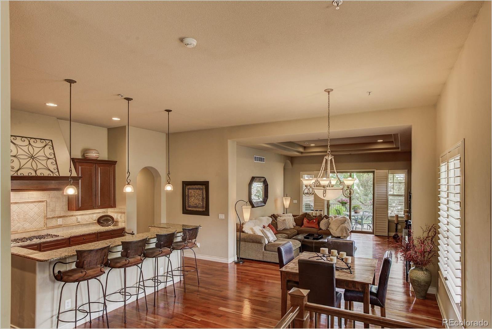4363 Chateau Ridge Lane Castle Rock, CO 80108 - Photo 12 of 32 a living room with lots of furniture and a chandelier