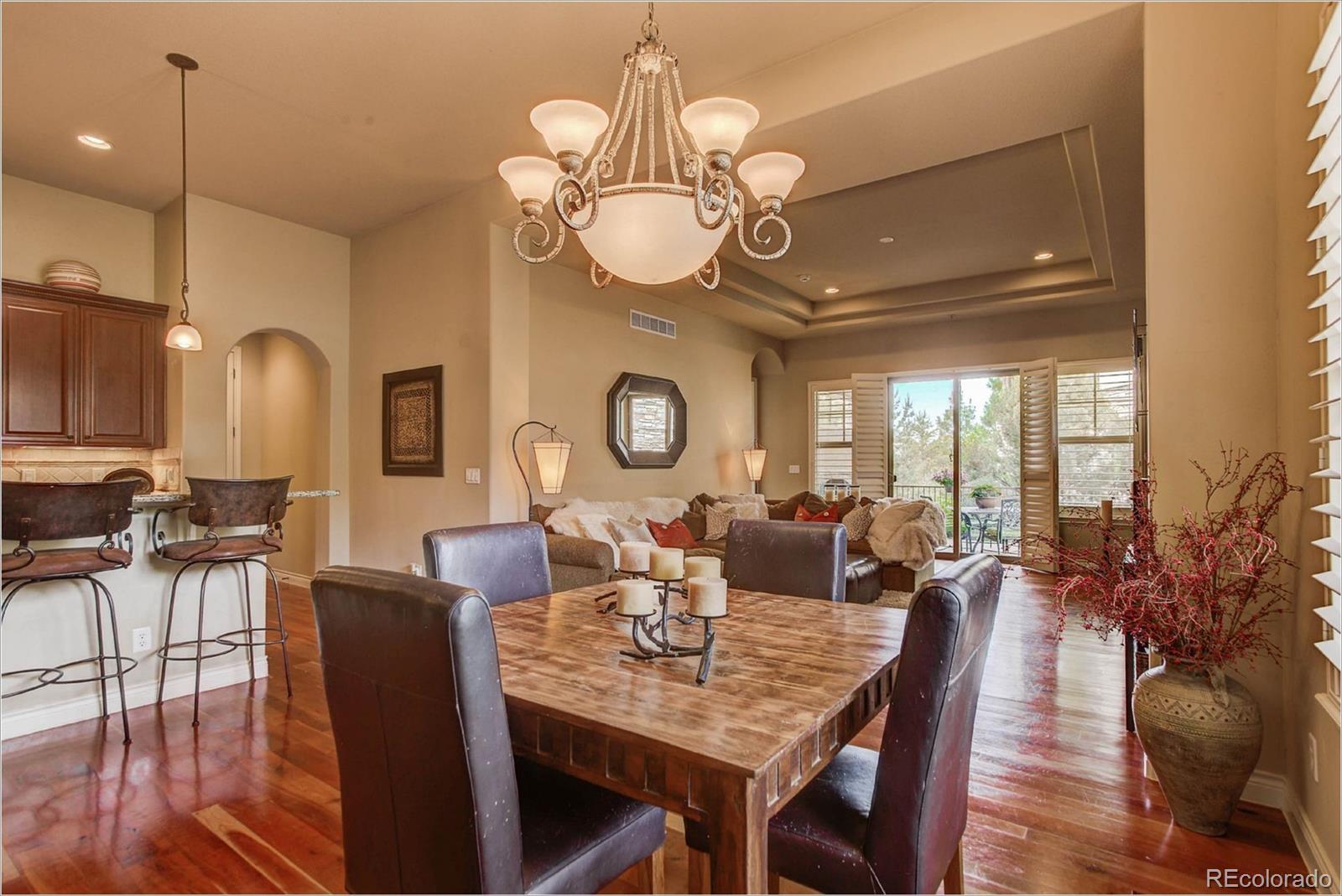 4363 Chateau Ridge Lane Castle Rock, CO 80108 - Photo 15 of 32 a view of a dining room with furniture a chandelier and wooden floor