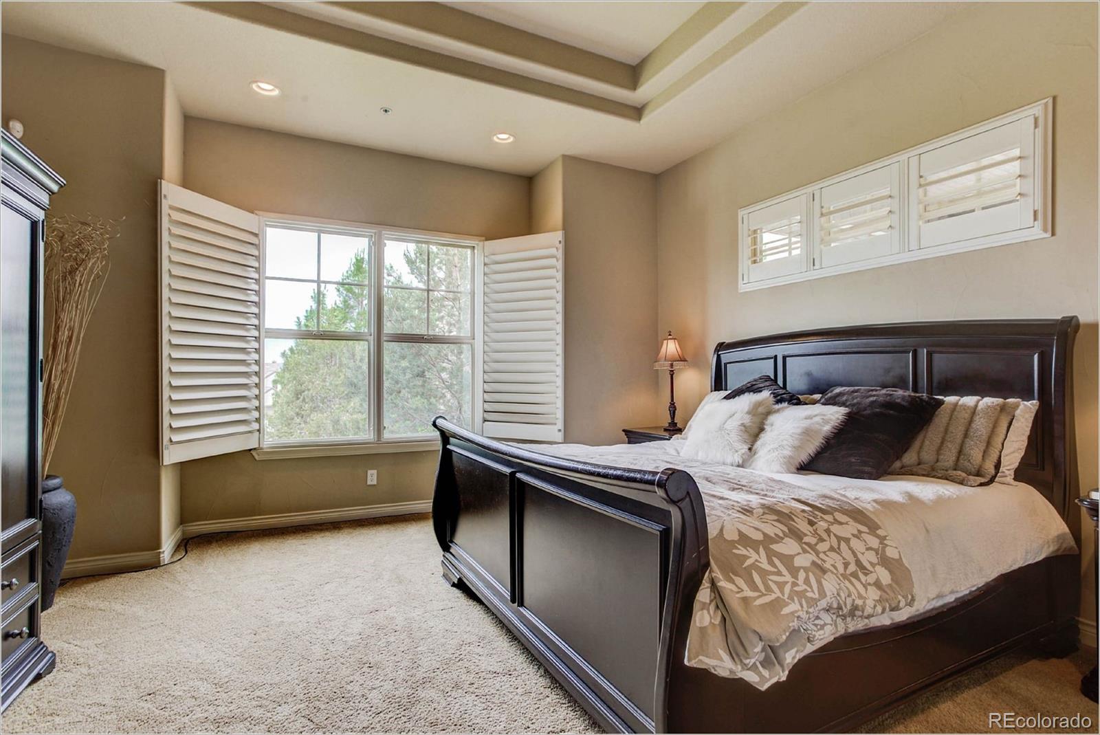 4363 Chateau Ridge Lane Castle Rock, CO 80108 - Photo 17 of 32 a bedroom with a bed and a window