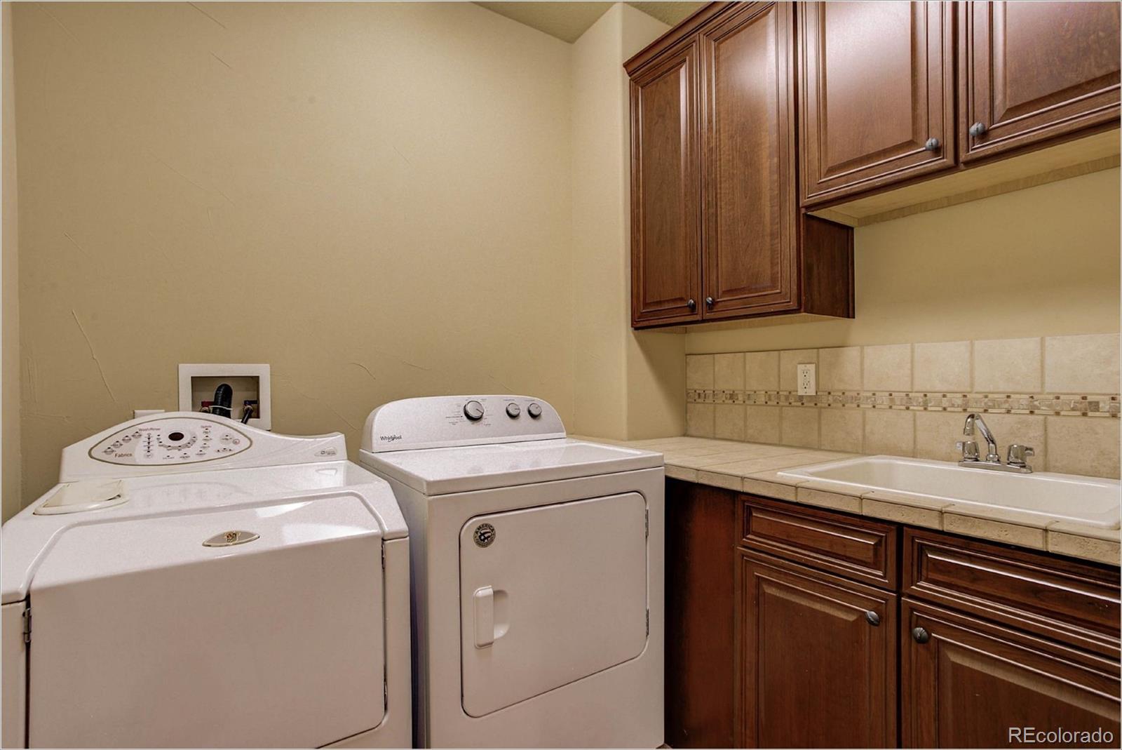 4363 Chateau Ridge Lane Castle Rock, CO 80108 - Photo 18 of 32 a utility room with dryer and washer