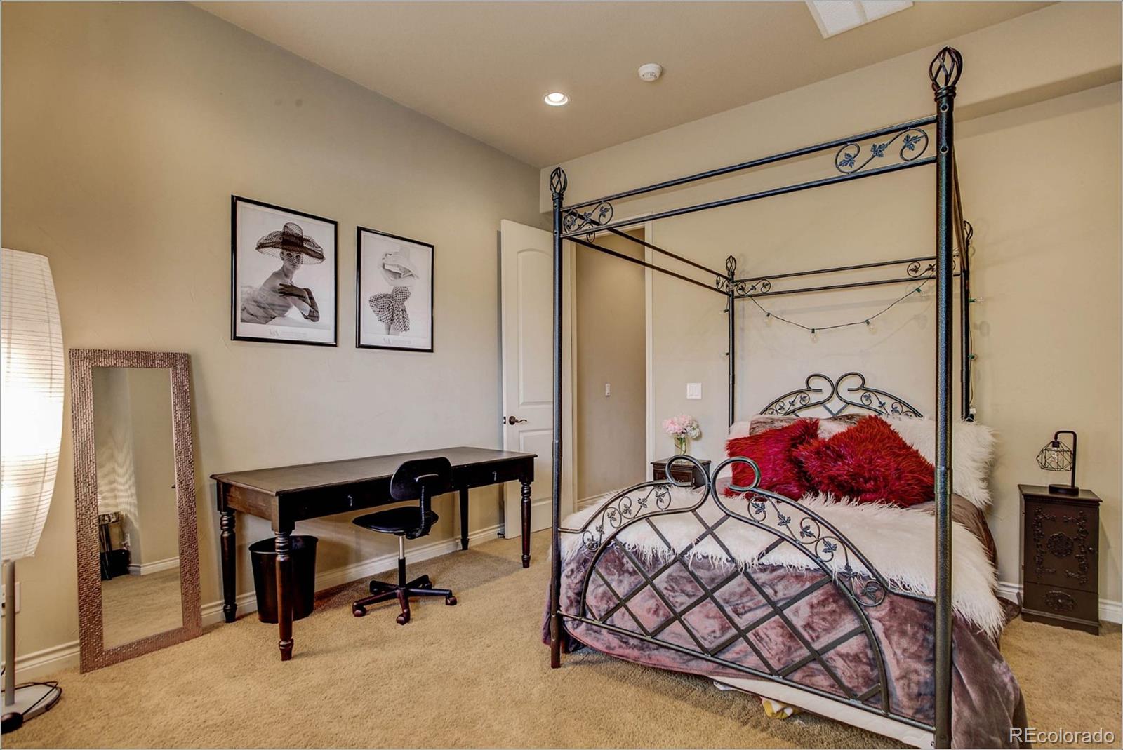 4363 Chateau Ridge Lane Castle Rock, CO 80108 - Photo 23 of 32 a bedroom with a bed a desk and chair