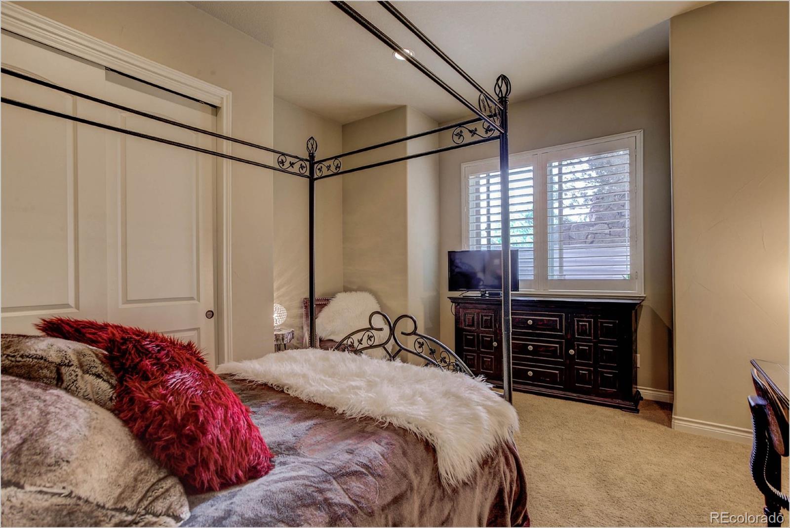 4363 Chateau Ridge Lane Castle Rock, CO 80108 - Photo 24 of 32 a bedroom with a bed and a dresser