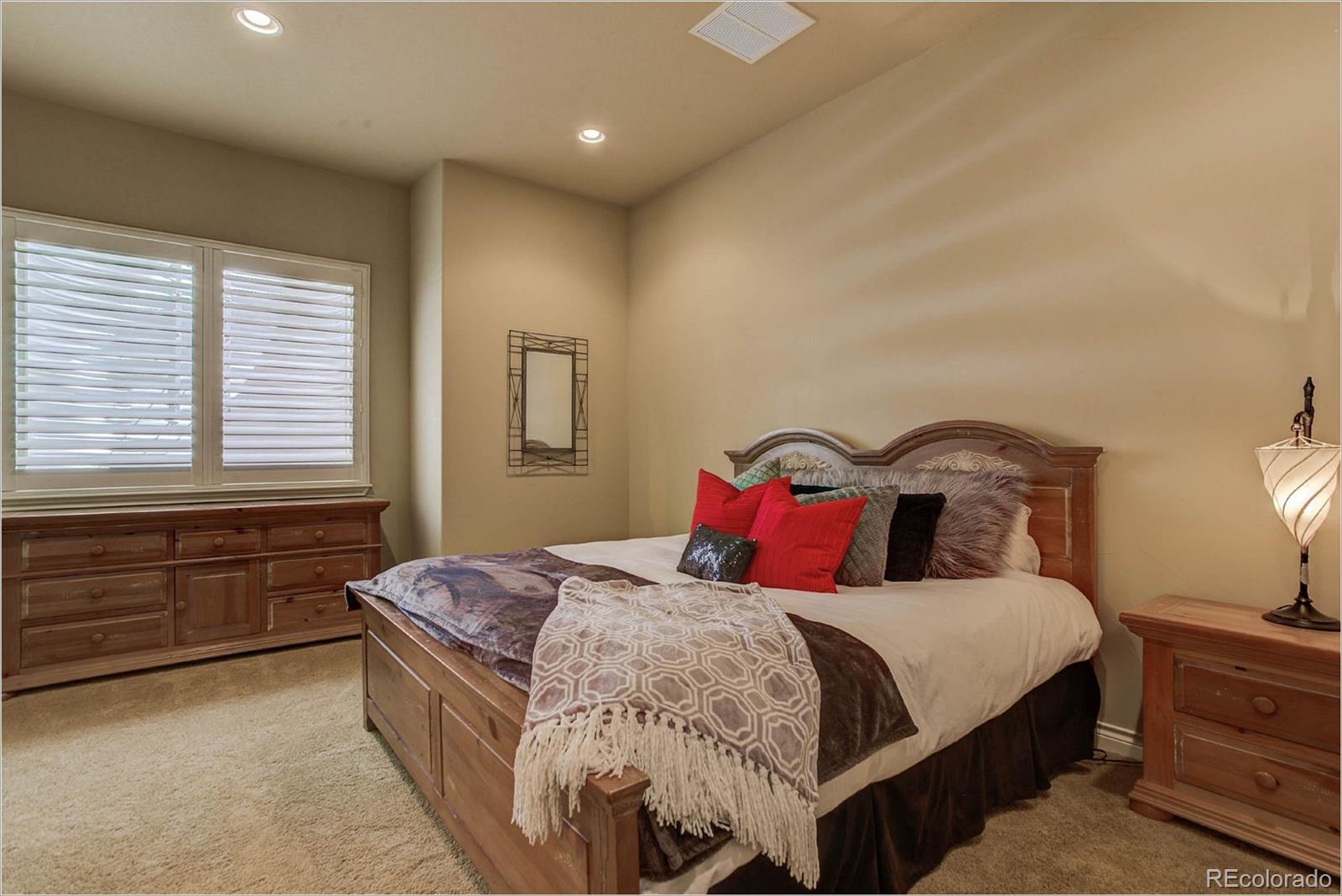 4363 Chateau Ridge Lane Castle Rock, CO 80108 - Photo 26 of 32 a bedroom with a bed and a window